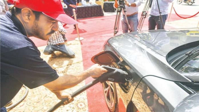 e-vehicle is being charged at a rapid charging station near the Karachi Press Club on Tuesday.—Fahim Siddiqi White Star